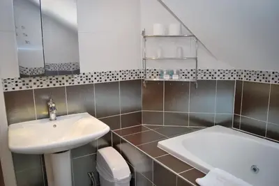 a bathroom with a sink and a bath tub at The Old Schoolhouse Hotel in Larkhall