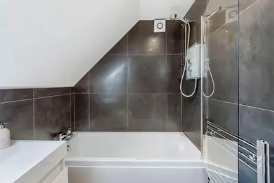 a bathroom with a shower and a bath tub at Wallace's Rest in Stirling