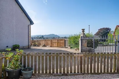 a wooden fence in front of a house at Wallace's Rest in Stirling