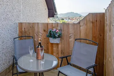 a table and two chairs and a bottle of wine at Wallace's Rest in Stirling