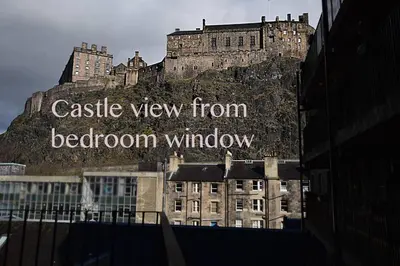 a castle view from beacon window sign on a building at JOIVY Bohemian Writers Retreat in Old Town in Edinburgh