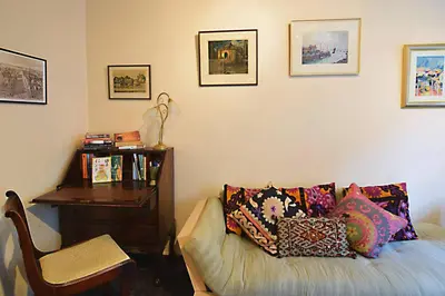 a living room with a couch and a desk at JOIVY Bohemian Writers Retreat in Old Town in Edinburgh