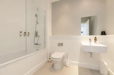 a white bathroom with a toilet and a sink at Destiny Scotland - Q-Residence in Edinburgh