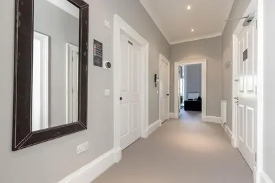 a hallway of a home with a mirror on the wall at Destiny Scotland - Q-Residence in Edinburgh