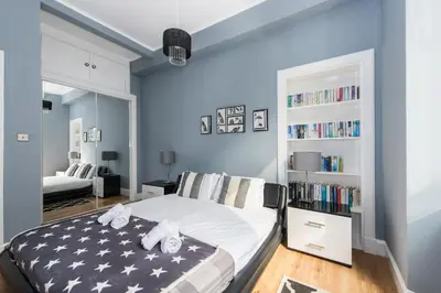 a bedroom with a bed and a book shelf at City Centre, 5 star Ground Floor in Edinburgh