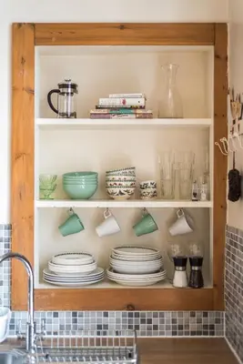 a kitchen shelf with plates and utensils at Spacious & Unique city central 1 bed with WiFi in Edinburgh