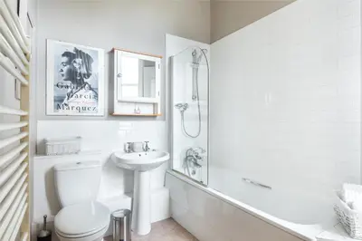 a white bathroom with a toilet and a sink at Spacious & Unique city central 1 bed with WiFi in Edinburgh