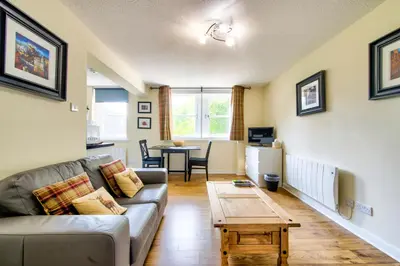 a living room with a couch and a table at Stunning Studio Apartment Castle View in Edinburgh