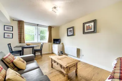 a living room with a couch and a table at Stunning Studio Apartment Castle View in Edinburgh