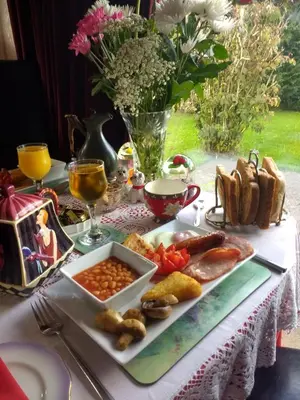 a table with a plate of food on a table at Lower Balwill in Buchlyvie