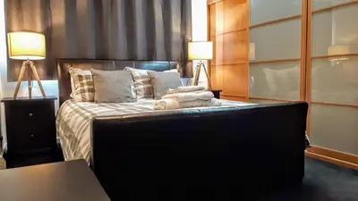 a bedroom with a bed with two stuffed animals on it at Elegant Apartment Near SECC/HYDRO in Finnieston, Glasgow in Glasgow