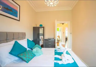 a bedroom with a bed with two swans on it at Clyde View Apartment in Helensburgh