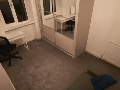 an office with a desk and a chair and a table at Sleep Well Apartment in Glasgow