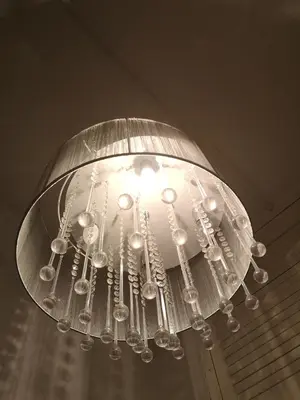 a large glass chandelier hanging from a ceiling at Sleep Well Apartment in Glasgow