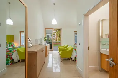 a hospital room with a bed and green chairs at Ardtorna in Benderloch