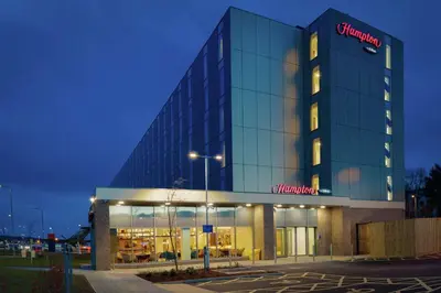 a building with a sign on the side of it at Hampton By Hilton Edinburgh Airport in Ingliston