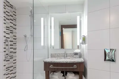 a bathroom with a sink and a mirror at Hampton By Hilton Edinburgh Airport in Ingliston
