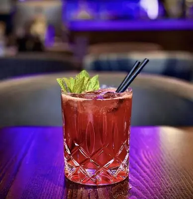 a drink on a table with a mint garnishment at The Ranald Hotel in Oban