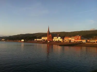 a large body of water with a town and a church at Largs stay With Private parking in Largs