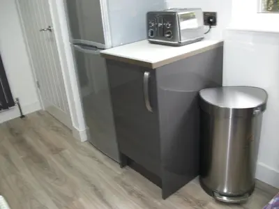 a kitchen with a counter with a toaster and a trash can at Westpark Apartment in East Kilbride