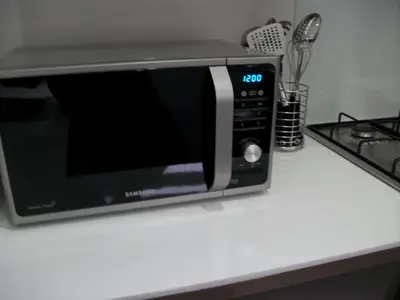 a microwave oven sitting on a counter next to a stove at Westpark Apartment in East Kilbride