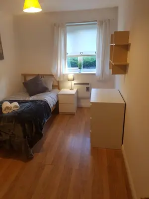 a small bedroom with a bed and a window at Livingston Business and Contractor Apartment in Livingston