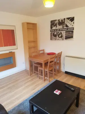 a living room with a table and chairs and a table sidx sidx at Livingston Business and Contractor Apartment in Livingston