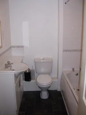 a bathroom with a toilet and a sink and a tub at Livingston Business and Contractor Apartment in Livingston