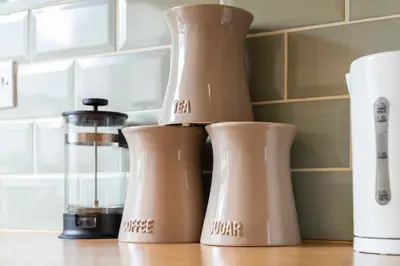 a group of three coffee makers sitting on a counter at Three Bed Holiday Home in Glasgow in Glasgow