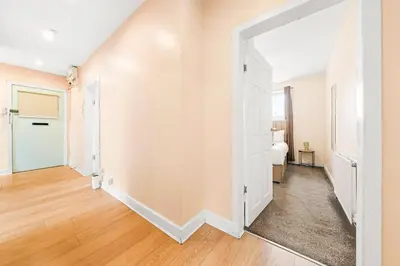 an empty hallway with a door leading to a bedroom at Three Bed Holiday Home in Glasgow in Glasgow