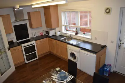 a kitchen with a sink and a dishwasher at Silverburn new house with free parking and nice garden in Glasgow