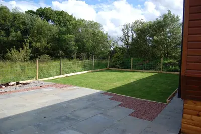 a yard with a fence and a field of grass at Ben View in Taynuilt