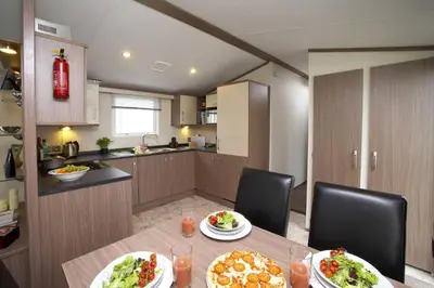 a kitchen with a table with two plates of food at Loch View in Taynuilt