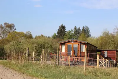 a small cabin in the middle of a field at Loch View in Taynuilt