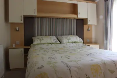 a bedroom with a bed with a white bedspread at Mountain View in Taynuilt