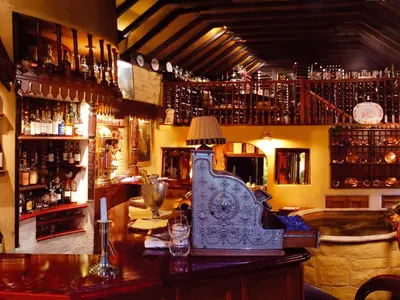 a bar with a table with a lamp on it at Champany Inn in Linlithgow