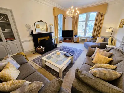a living room with a couch and a table at Lochwood Guest House in Lochgoilhead