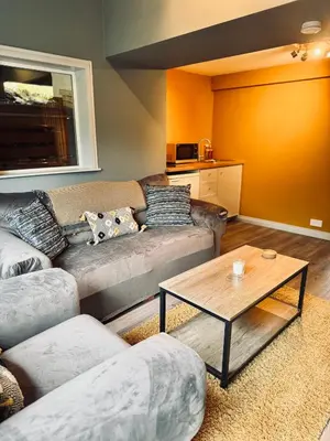 a living room with a couch and a coffee table at Lochwood Guest House in Lochgoilhead