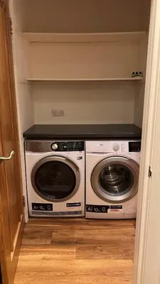 a laundry room with a washer and dryer at Glenisle Cottage in Lamlash