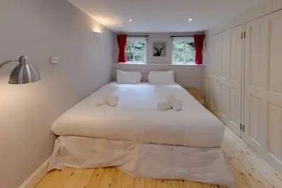 a bedroom with a large white bed with two pillows at JOIVY Warm & Welcoming Flat near Edinburgh Castle in Edinburgh
