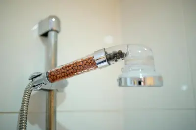 a shower head in a bathroom with a hose at Central Stay on Main st- Harbour Views in Oban