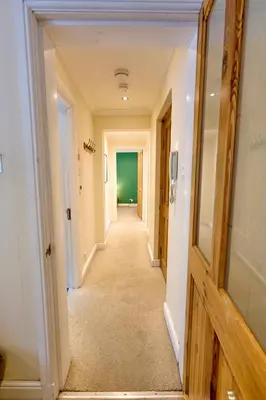 a hallway of a house with a long corridor at Central Stay on Main st- Harbour Views in Oban