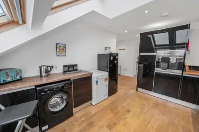 a kitchen with a washer and dryer in a house at Stunning 2BR Loft Apt in Oban - Sea Views in Oban