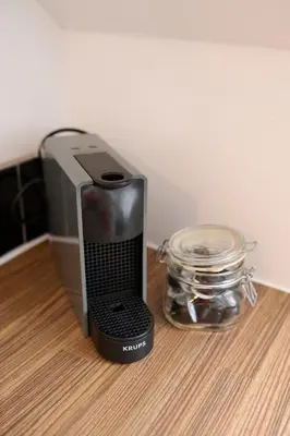 a speaker sitting on a counter next to a glass jar at Stunning 2BR Loft Apt in Oban - Sea Views in Oban