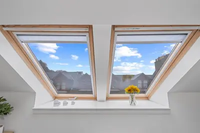 two windows in a room with a vase of flowers at Stunning 2BR Loft Apt in Oban - Sea Views in Oban