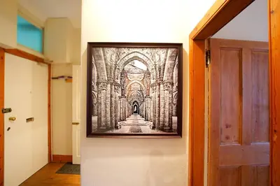a picture hanging on a wall next to a door at JOIVY Classic Apt with Castle Views in Old Town in Edinburgh