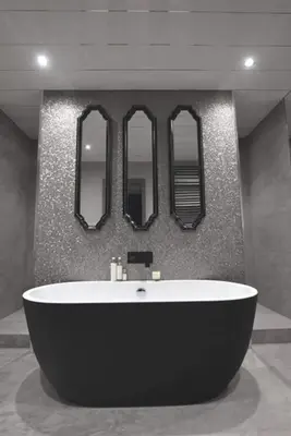 a bath tub in a bathroom with four mirrors at Richmond Park Hotel in Boʼness