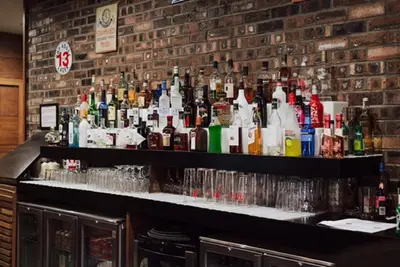 a bar with a lot of bottles of alcohol at Richmond Park Hotel in Boʼness