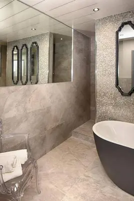 a bathroom with a tub and a large mirror at Richmond Park Hotel in Boʼness