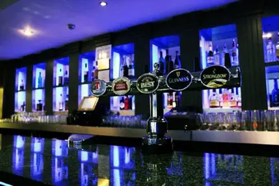 a bar with a bunch of bottles of alcohol at Richmond Park Hotel in Boʼness